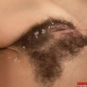 Brunette with small tits gets a cumshot on her hairy pussy