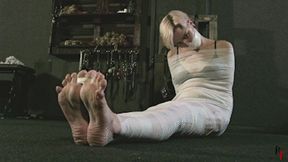 Barefoot Astrid gets mummified with white bandages and gagged tightly (HD 720p MP4)