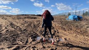 A girl in very high-heeled shoes walks on a super dirty road so that her shoes turn into pieces of earth very quickly