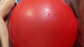 Girl deflate ball on balcony