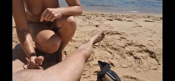 Stepsister gives nude blowjob to stepfather on a beach