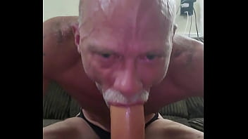 Sucking on a realistic cock