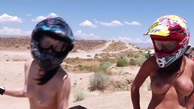 Big boobed badass nude babes trying motocross in the desert