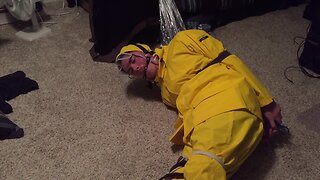 Self-bondage in yellow pvc rainsuit