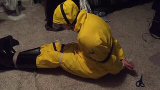 Self-bondage in yellow pvc rainsuit
