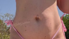 A thick MILF oiled up in a micro bikini and big ol milky boobs!