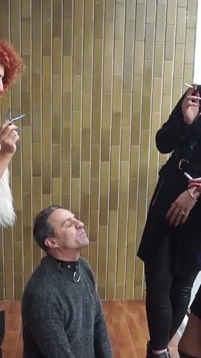 Fur-clad Femdoms Dominate Submissive on Balcony