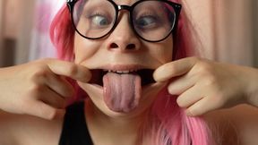 My stepsister is making ahegao faces really silly, goofy expressions playing with her tongue and stretching her mouth wide, all while playing with a dildo and pulling crazy faces.