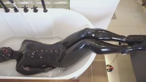 Taking a bath while wearing latex clothing