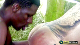 A big black African cock fucks a sexy tattooed Latino guy in the countryside. - Big Bamboo Salvage