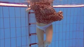 ”Redhead Katka playing underwater”