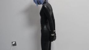 An Asian girl wearing a leather jacket, handcuffed and shackled, with metal straps to the soles of her feet, could not touch the ground and could only stand on tiptoe. She stood in this position for half an hour.