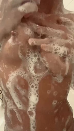 young slut spits on her foamy tits in the shower