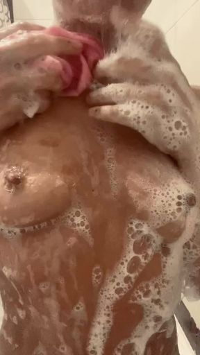 young slut spits on her foamy tits in the shower