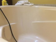 Taking in an enema in the bathtub