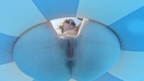 Cute and skinny blonde swims on a lifebuoy without panties and u can see her lovely pussy