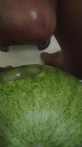 Native Indian lone boy punching his fist with watermelon in the field