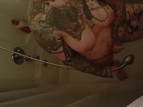 Chubby tattooed milf squirts in shower 2 times. Seductive feet.