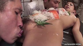 Japanese secretary covered with food and her colleagues lick her