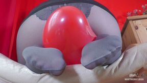 Mistress in gray opaque pantyhose and high heels plays with balloons
