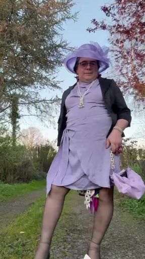 Dressed in a lilac dress and a hat for an evening