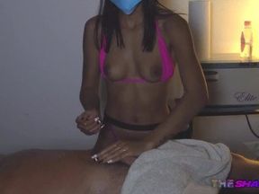 Masked masseuse in bikini with client