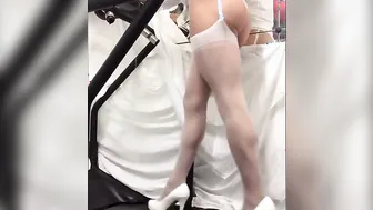 Crossdresser in white tights walking on treadmill solo