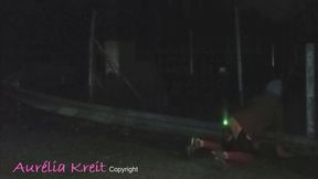 Exhibition at night in safety access off the A7 motorway. lighting anal plug and caged cock