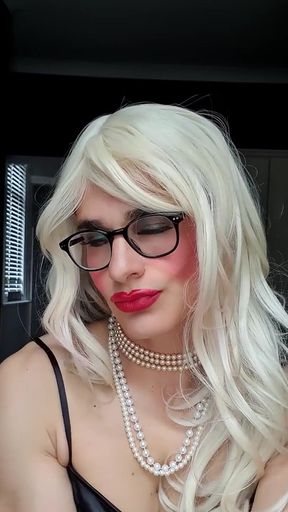 Teasing you in my black satin dress, full make up, pearls, opera leather gloves, stockings, suspenders, pearls, chastity, blonde