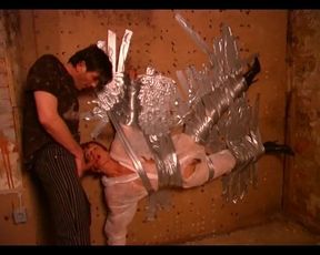 Dominus Ronaldo taped his redheaded slave to the wall and lets her suck him in that position