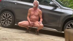 Naked man pleases himself with hand and outdoor setting