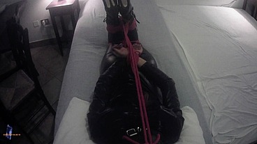 Laura is hogtied in latex catsuite and high heels, throated with a lip open mouth gag POV