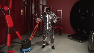 Blonde girl in black latex catsuit full encased in inflatable rubber and full body plastic suit