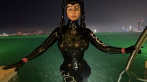 Rubbermissy in Full rubber enclosure with latexmask and Dorset having a Pool side cooldown in Dubai
