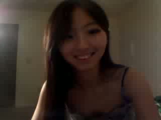 Cute Asian brunette teen stripteasing on webcam and playing