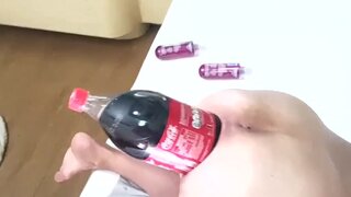 Big soda bottle is penetrating her tight asshole