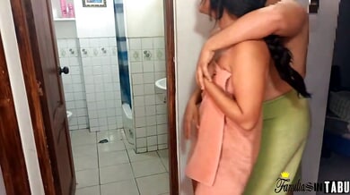 Wet skin glistens in the bathroom as a couple shares an intimate moment after showering