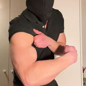 Young muscle hunk strips in balaclava