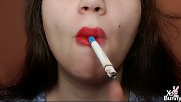 Close up of red lips smoking