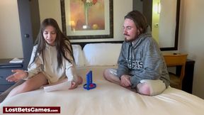 Strip Connect 4 game on the bed, losing clothes as she plays