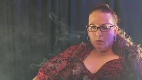 Sitting in a red blouse smoking a Virginia Slims menthol 120 playing with a rose