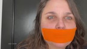 Gag talk with orange bondage tape on my small lips