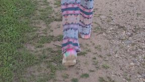 Chrissy walking outside in crocs and pajamas