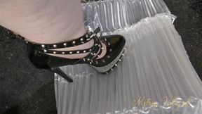 Packaging popping in spiked fetish heels