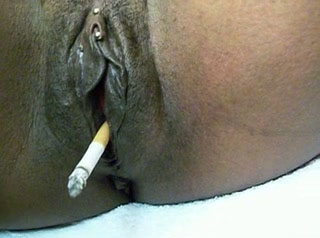 Big black shiny pussy smoking a cigarette on webcam