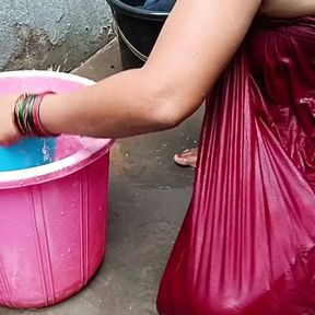 Indian housewife bathing with