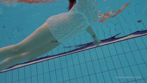 Watch petite Russian hottie Katy Soroka swim with her tight body and perfect ass in the pool