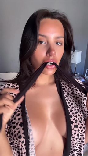Blonde woman in leopard print lingerie holding a hairbrush