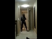 wearing wetsuit and fins shoot a quick load at open hotel door