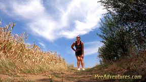 Chubby brunette pee on a dirt road in the middle of no-were